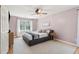 Comfortable bedroom with soft pink walls, plush carpet, and a large window offering scenic views at 109 Buckingham Ave, Summerville, SC 29485