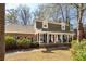 Classic two-story brick home with a covered front porch, American flag and mature landscaping at 109 Buckingham Ave, Summerville, SC 29485
