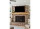 Close-up of the living room brick fireplace with wood mantle and built-in shelving at 109 Buckingham Ave, Summerville, SC 29485