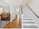 Bright hallway with hardwood floors, stairs, and views into the living room and other areas at 109 Buckingham Ave, Summerville, SC 29485