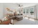 Bright living room with a large sofa, ceiling fan, and plenty of natural light streaming through the windows at 109 Buckingham Ave, Summerville, SC 29485