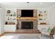 Bright living room with a brick fireplace, built-in shelves, and comfortable seating at 109 Buckingham Ave, Summerville, SC 29485