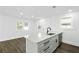 Modern kitchen with island, sleek sink, and ample natural light showcasing the stylish design at 109 Harper St, Walterboro, SC 29488