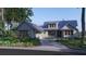 Charming gray craftsman home with metal roof, covered porch, and a curved driveway at 111 Peninsula Dr, Ravenel, SC 29470