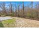 Large backyard with a concrete patio and perimeter of trees and greenery at 1174 Old Field Dr, Summerville, SC 29483