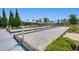Outdoor bocce ball court near community clubhouse, surrounded by lush landscaping and trees at 1174 Old Field Dr, Summerville, SC 29483