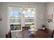 Bright dining room featuring a wooden table, stylish decor, and a window overlooking a serene outdoor view at 1174 Old Field Dr, Summerville, SC 29483