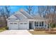 Charming home with a two-car garage, inviting front porch, and manicured landscaping, perfect for suburban living at 1174 Old Field Dr, Summerville, SC 29483