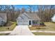 Inviting exterior of a home featuring a two-car garage, welcoming front porch, and well-maintained landscaping at 1174 Old Field Dr, Summerville, SC 29483