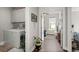 Open hallway view from the laundry room toward a living area and bedroom at 1174 Old Field Dr, Summerville, SC 29483