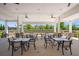 Outdoor covered seating area with multiple tables and chairs, perfect for relaxing and socializing at 1174 Old Field Dr, Summerville, SC 29483