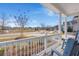 Inviting porch view with rocking chairs, offering a glimpse of a serene neighborhood and a nearby pond at 1174 Old Field Dr, Summerville, SC 29483