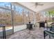 A screened porch with grill, wicker furniture, and an outdoor view at 1174 Old Field Dr, Summerville, SC 29483