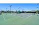 Several outdoor tennis courts with green surfaces and high nets are fenced in for recreational play at 1174 Old Field Dr, Summerville, SC 29483