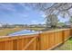 Scenic backyard view with a wooden fence overlooking a tranquil pond at 118 Lamplighter Ln, Summerville, SC 29486