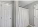 Bright bathroom featuring a walk-in shower with a white shower curtain and neutral colored tile flooring at 118 Lamplighter Ln, Summerville, SC 29486