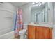 This bathroom features a tub with shower, sink with vanity, floral curtain, and a large mirror at 118 Lamplighter Ln, Summerville, SC 29486