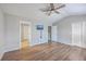 Open bedroom space featuring hardwood floors, a ceiling fan, closets, and ensuite bathroom access at 118 Lamplighter Ln, Summerville, SC 29486