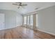 Vaulted ceiling bedroom featuring hardwood floors, a ceiling fan, and three windows with stylish curtains at 118 Lamplighter Ln, Summerville, SC 29486
