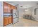 Open kitchen featuring stainless steel refrigerator, wooden cabinets and dining area at 118 Lamplighter Ln, Summerville, SC 29486