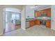 Bright kitchen featuring wooden cabinets, stainless steel appliances, and an adjoining living space at 118 Lamplighter Ln, Summerville, SC 29486