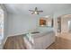 Open-concept living room with wood floors, a gray sofa, and a view into the adjacent kitchen area at 118 Lamplighter Ln, Summerville, SC 29486
