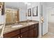 Bathroom featuring a granite double sink vanity with dark cabinets and walk-in shower at 1309 Belgian Draft Dr, Mount Pleasant, SC 29466