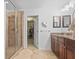 Elegant bathroom featuring glass-enclosed shower, double vanity with granite countertops, and walk-in closet at 1309 Belgian Draft Dr, Mount Pleasant, SC 29466