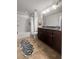 Bathroom featuring a granite double sink vanity with dark cabinets, tub, shower with a white curtain at 1309 Belgian Draft Dr, Mount Pleasant, SC 29466