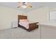 Bedroom with light yellow walls, carpeted floor, and wood frame bed with matching bedside table at 1309 Belgian Draft Dr, Mount Pleasant, SC 29466