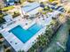 A lovely community pool with a covered lounge area, palm trees, pool furniture, and an adjacent pool house at 1309 Belgian Draft Dr, Mount Pleasant, SC 29466