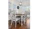 Bright dining room boasts a modern light fixture, hardwood floors, and sliding doors to the outside patio at 1309 Belgian Draft Dr, Mount Pleasant, SC 29466