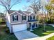 Charming two-story home with a white garage door, dark shutters, and a manicured lawn at 1309 Belgian Draft Dr, Mount Pleasant, SC 29466