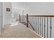 Hallway showcasing decorative railings and an inviting reading nook with comfortable armchair at 1309 Belgian Draft Dr, Mount Pleasant, SC 29466