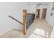Hallway with carpet and a staircase featuring decorative black metal and wood railings at 1309 Belgian Draft Dr, Mount Pleasant, SC 29466