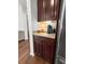 Granite counters and dark wood cabinets accent this kitchen with stainless steel appliances and a coffee bar at 1309 Belgian Draft Dr, Mount Pleasant, SC 29466