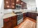 Cherry cabinets and stainless appliances accent this kitchen with white backsplash and granite countertops at 1309 Belgian Draft Dr, Mount Pleasant, SC 29466