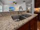 Granite countertops highlight this kitchen with double sinks and modern fixtures at 1309 Belgian Draft Dr, Mount Pleasant, SC 29466
