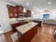 Well-appointed kitchen with cherry cabinets, granite countertops, a central island and stainless appliances at 1309 Belgian Draft Dr, Mount Pleasant, SC 29466