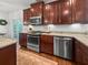 Kitchen features dark wood cabinets, stainless appliances, granite counters, and access to the backyard at 1309 Belgian Draft Dr, Mount Pleasant, SC 29466