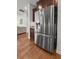 Stainless steel LG fridge and hardwood flooring in this open concept kitchen at 1309 Belgian Draft Dr, Mount Pleasant, SC 29466