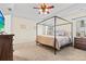 Airy bedroom with a four-poster bed, large windows, and plush carpeting at 1309 Belgian Draft Dr, Mount Pleasant, SC 29466