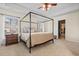 Spacious bedroom with a four-poster bed, ceiling fan, and ample natural light at 1309 Belgian Draft Dr, Mount Pleasant, SC 29466