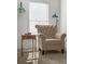 Comfortable armchair and side table by the window, perfect for reading and relaxing at 1309 Belgian Draft Dr, Mount Pleasant, SC 29466
