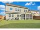 Green backyard featuring a screened patio, providing ample outdoor space for recreation at 131 Swaying Palm Dr, Summerville, SC 29485