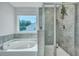 Bathroom showcases a soaking tub and walk-in shower with tiled walls, plus a view from the window at 131 Swaying Palm Dr, Summerville, SC 29485