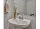Close-up of modern powder room with pedestal sink, sleek faucet, and convenient wall-mounted towel rack at 131 Swaying Palm Dr, Summerville, SC 29485