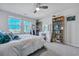 Comfortable bedroom with a ceiling fan, a bed with pillows, a makeup vanity, and a bookshelf at 131 Swaying Palm Dr, Summerville, SC 29485