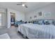 This bedroom features a walk-in closet, comfortable bedding, carpeted floors, and bright, neutral walls at 131 Swaying Palm Dr, Summerville, SC 29485