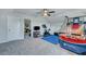 Carpeted bonus room featuring an exercise bike, basketball game, and doorway to another room at 131 Swaying Palm Dr, Summerville, SC 29485
